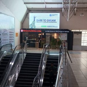 Outdoor Billboards advertising agency in Lagos Nigeria - DSTV- BRT Branding and Digital Marketing 56 Digital Billboard escalator from Check-in to Departure - 025, Lagos.